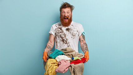 Photo of annoyed redhead man shouts desperately angrily, being dirty, cries from despair, has...