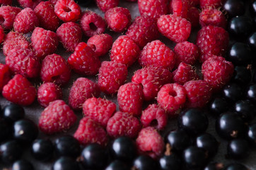 Bunch of fresh raspberries and black currants. Close-up view
