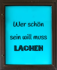 Sign: He who wants to be beautiful must laugh- Wer schön sein will muss lachen