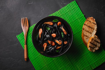 Black squid ink Fettuccine pasta with prawns or shrimps , parsley, chili in wine and butter sauce