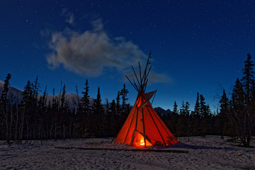 Teepee in the forest at night