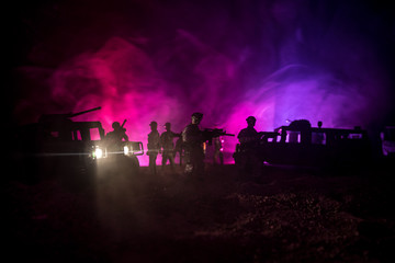 Obraz na płótnie Canvas War Concept. Military silhouettes fighting scene on war fog sky background, Fighting silhouettes Below Cloudy Skyline At night. Battle scene. Army vehicle with soldiers. army