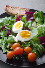 Fresh vegetarian salad with tomatoes, cheese and eggs. Close-up top view