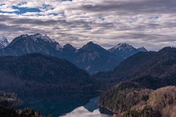  The beautiful view from Neuschwanstein castle with the grand beautiful mountain, lake, and clouds. Hohenschwangau, Germany