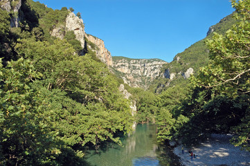 Fototapeta na wymiar The Vikos Gorge (Voidomatis river) is in the Pindus Mountains of northern Greece