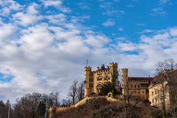 Hohenschwangau castle in the blue sky and coulds in winter. Hohenschwangau, Germany