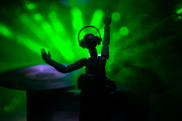 Dj club concept. Woman DJ mixing, and Scratching in a Night Club. Girl silhouette on dj's deck,...