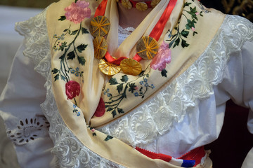 Girl dressed in traditional regional folk costumes in the church at the Mass on Thanksgiving day in...