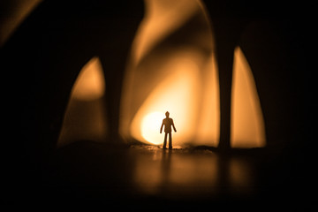 Artwork decoration. Silhouette of a man standing in the middle of the road on a misty night with...