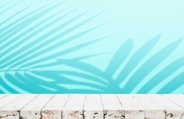 Summer and nature product display with wood table counter on blur coconut leaf background in blue color