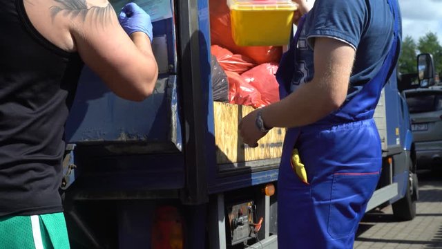 Handing a needle box or sharps container over to a registered biomedical waste transporter