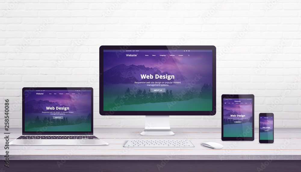 Poster Web design studio concept with flat design responsive web site on display devices. Office work desk with brick wall in background.