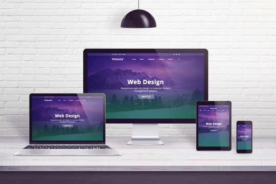 Responsive web site on multiple different display devices. Concept of web design, development work desk.