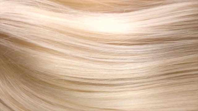 Hair. Beautiful healthy long straight blonde hair close-up texture. Dyed Wavy white blond hair background, coloring, extensions, cure, treatment concept. Haircare. Slow motion 4K UHD video