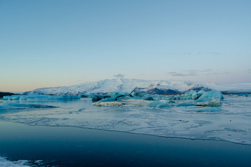 Naklejka na ściany i meble Frozen over seawater with Glacier in background