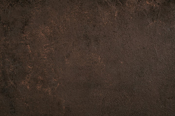 Dark brown painted textured surface with golden spots