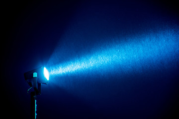 spotlight through the snow in the night sky