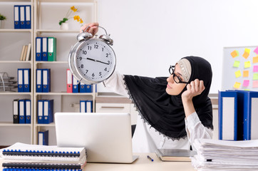 Female employee in hijab working in the office 