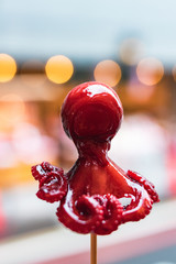 Tako Tamago, baby octopus on a stick. A japanese street food specialty, baby octopus with a quail egg inside, candied and skewered.