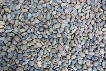 Textured of colorful crushed stones on the seashore.