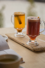 Hot mulled wine with apples pomegranate orange anise and cinnamon with fresh fruits on wooden table. Winter and fall. Christmas and holidays food.