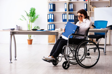 Female employee in wheel-chair at the office  