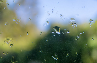 view behind a glass wet from the rain