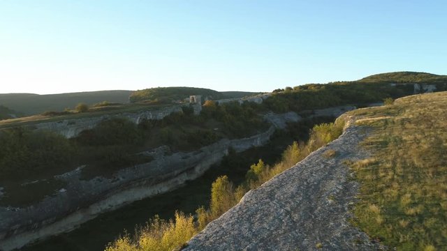Gorges and mountain peak under blue sky. Shot. Aerial view of mountain landscape.