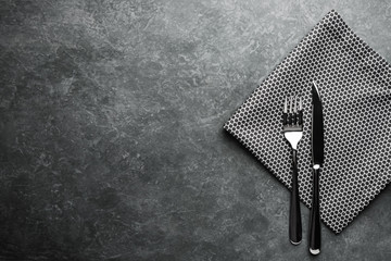 Cutlery on the table. Fork and knife with napkin. Top view.