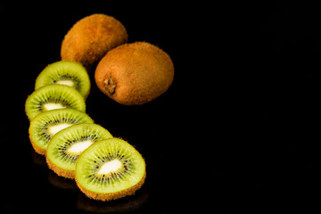kiwi, sliced ​​kiwi on a black background