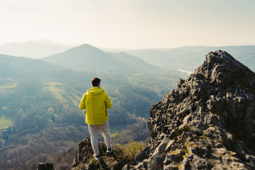 Photographer looks into the landscape and listen the silence. Conceptual scene. He was wearing...