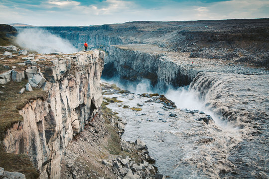 Hiker at gigantic Dettifoss waterfall in Iceland