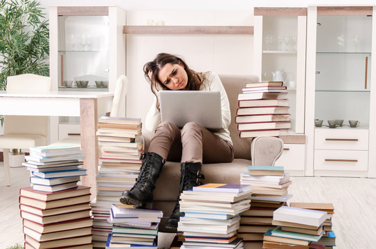 Young female student preparing for exams at home 