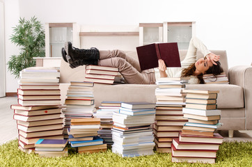 Young female student preparing for exams at home 
