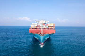 Ultra large container vessel (ULCV 366 Meters long) loaded with various Container brands, at sea - Aerial image.
