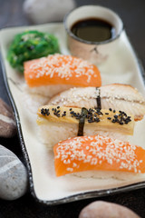 Set of nigiri susi on a plate, selective focus, closeup, vertical shot