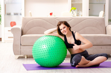 Young beautiful girl doing exercises with fitball