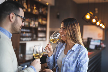 Couple in a restaurant tasting wine
