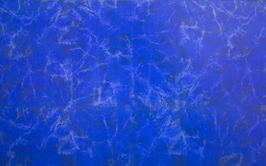 dark blue wall surface with white and black spots of mildew and dirt. rough texture