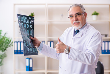Aged male doctor radiologist in the clinic 