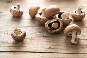 Mushrooms champignons royal scattered on a wooden background