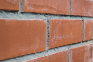 Obraz premium Closeup perspective view of a red brick wall, selective focus