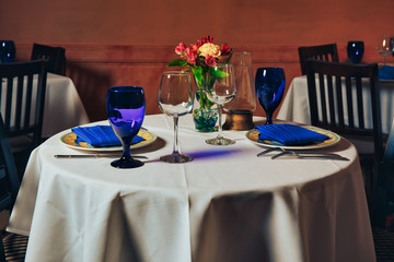 Empty indoor restaurant table. blue glasses set in restaurant 