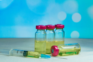 The vaccine in the vial with a syringe