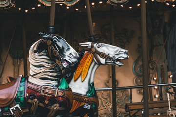 Fototapeta na wymiar Retro French carousel with two beautiful horses. Close up view.