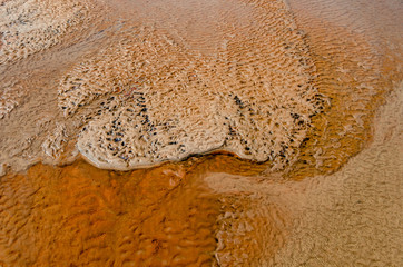 Closeup, clay, rust colored river bed abstract
