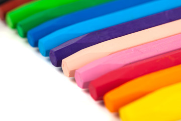 Group of crayons (pencils) stacked on white background