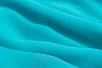folded blue textile background selective focus