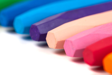 Group of crayons (pencils) stacked on white background