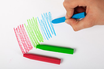 Close up of artists hand painting with crayon